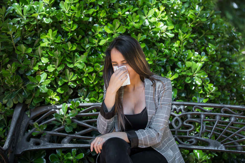 Woman with allergies outdoors