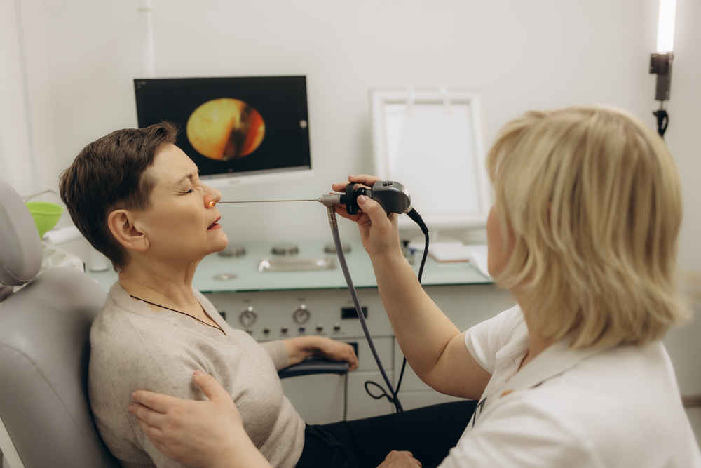 ENT doctor using sinus scope on patient