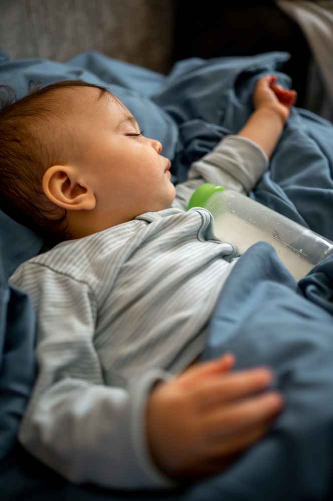 Young child sleeping with pediatric obstructive sleep apnea