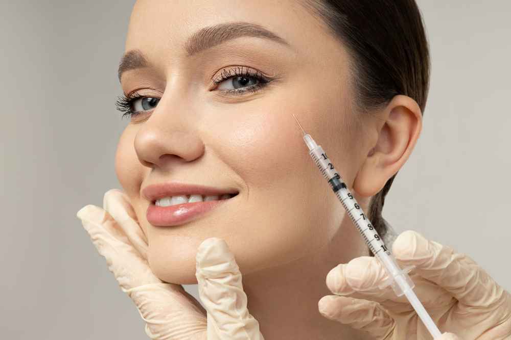 Woman being injected with a dermal filler in her face