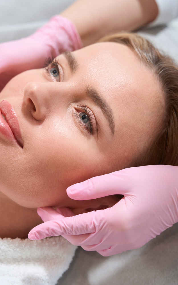 Facial plastic surgeon showing off patient's face after facial implants surgery