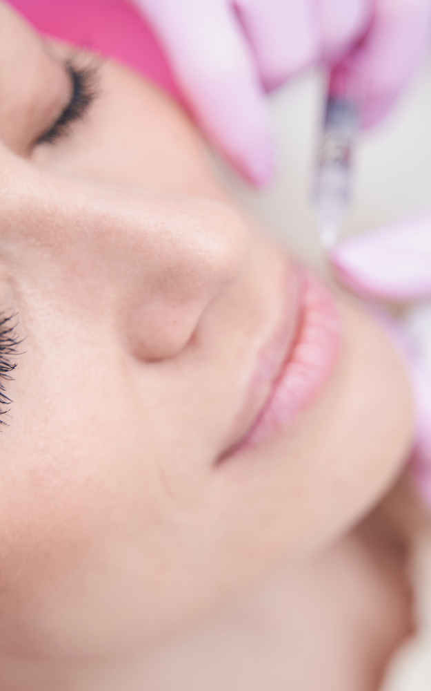 Facial plastic surgeon injecting neurotoxins into patient's face