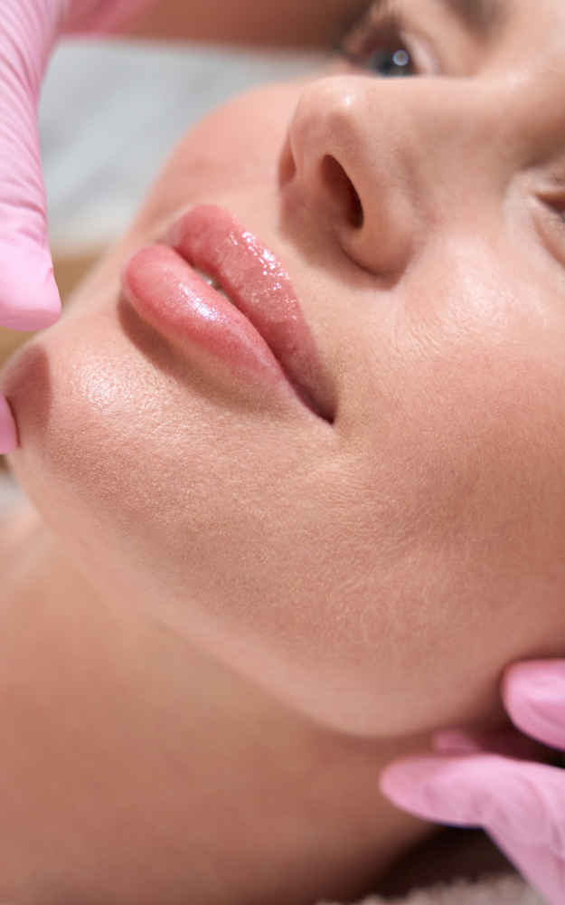 Facial plastic surgeon showing off patient's face after injecting dermal fillers