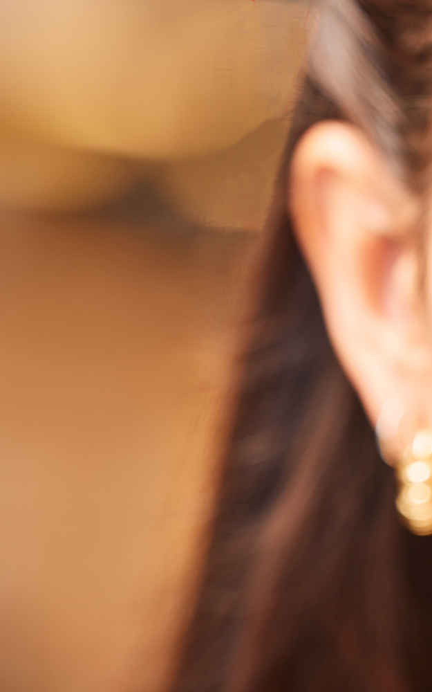 Woman before otoplasty ear pinning surgery