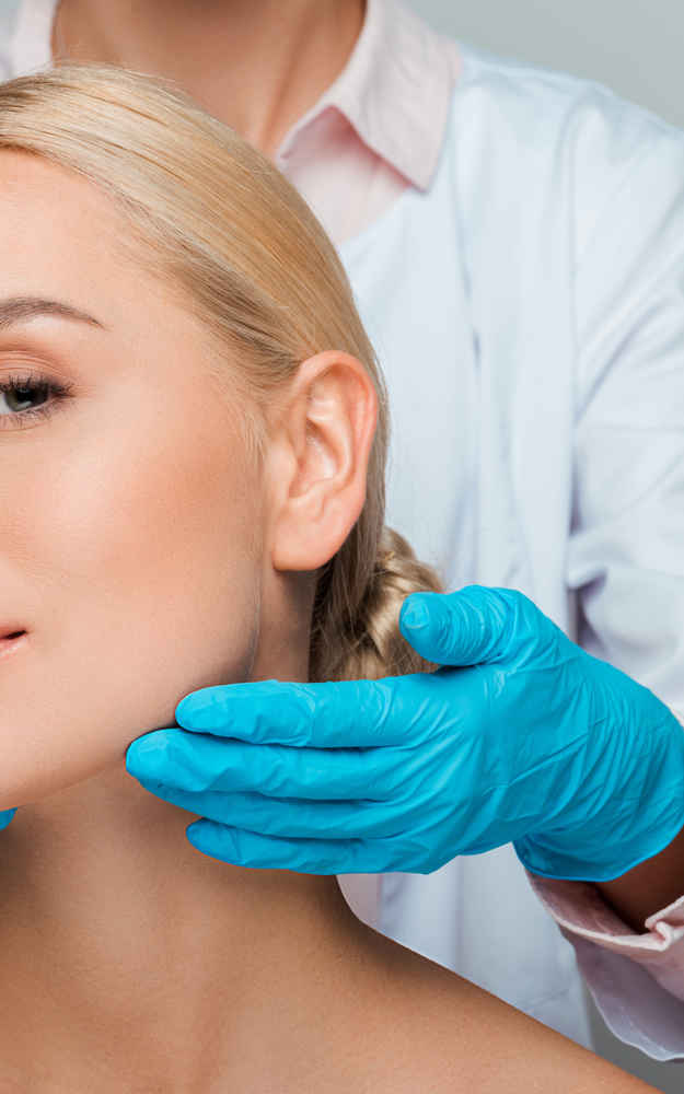 Facial plastic surgeon showing off patient's face after facelift surgery