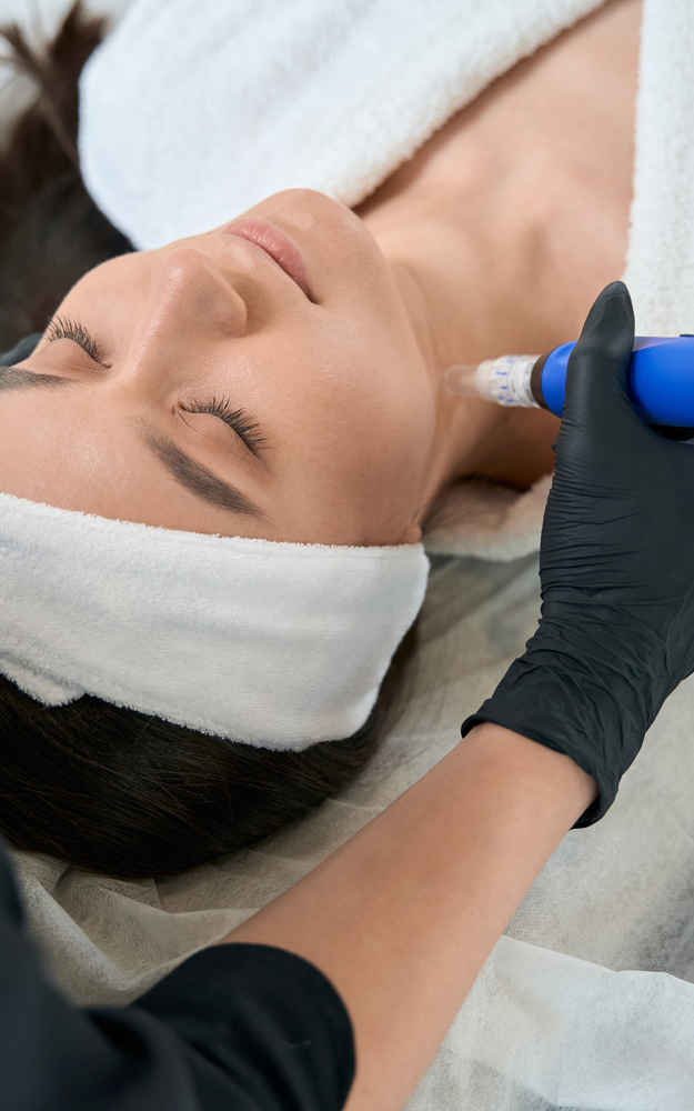 Facial plastic surgeon using SkinPen microneedling pen on patient's neck