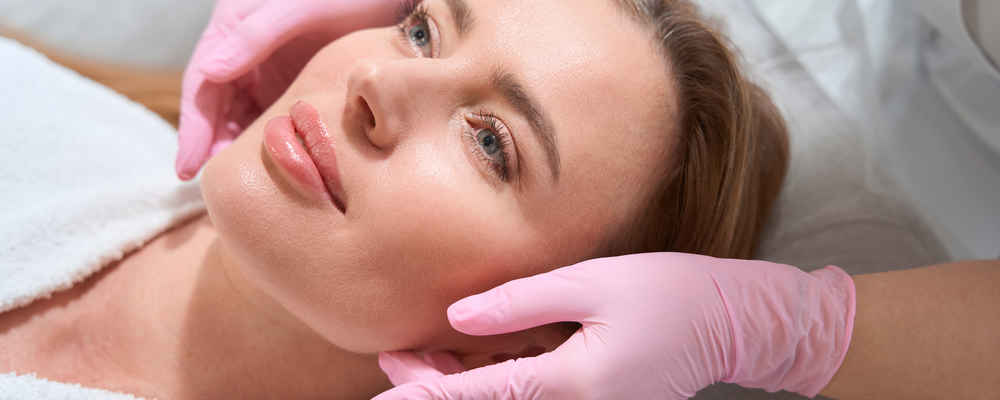 Facial plastic surgeon showing off patient's face after facial implants surgery