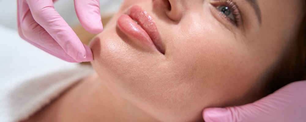 Facial plastic surgeon showing off patient's face after injecting dermal fillers