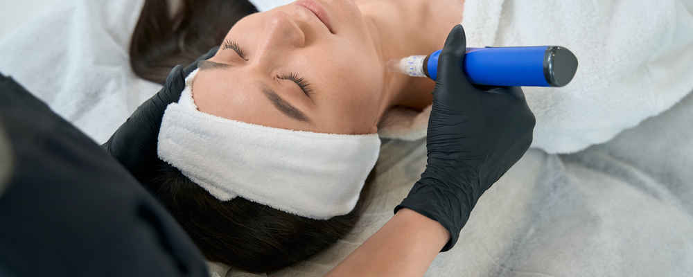 Facial plastic surgeon using SkinPen microneedling pen on patient's neck