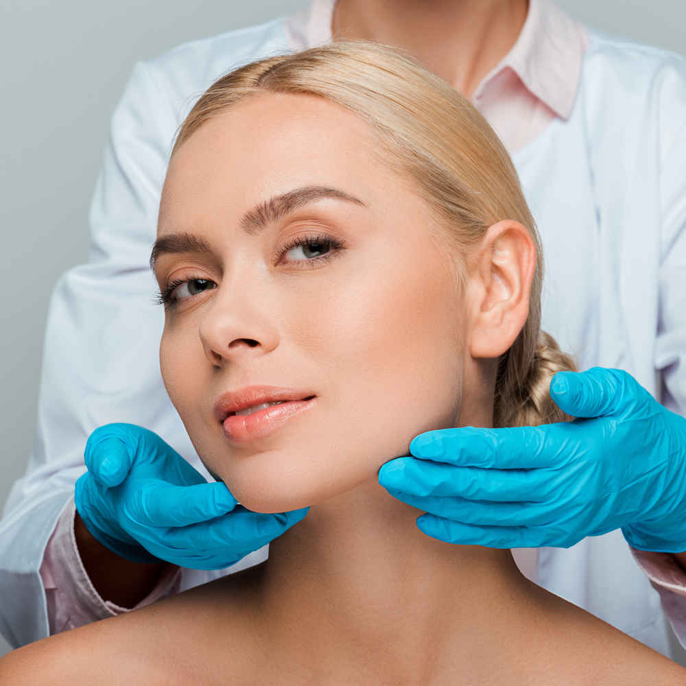 Facial plastic surgeon showing off patient's face after facelift surgery