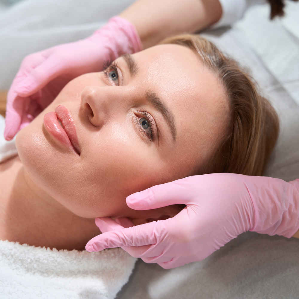 Facial plastic surgeon showing off patient's face after facial implants surgery