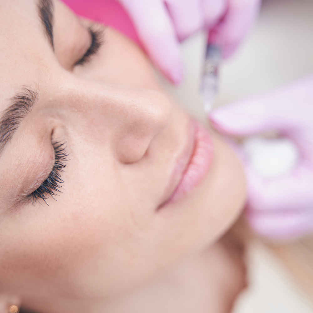 Facial plastic surgeon injecting neurotoxins into patient's face