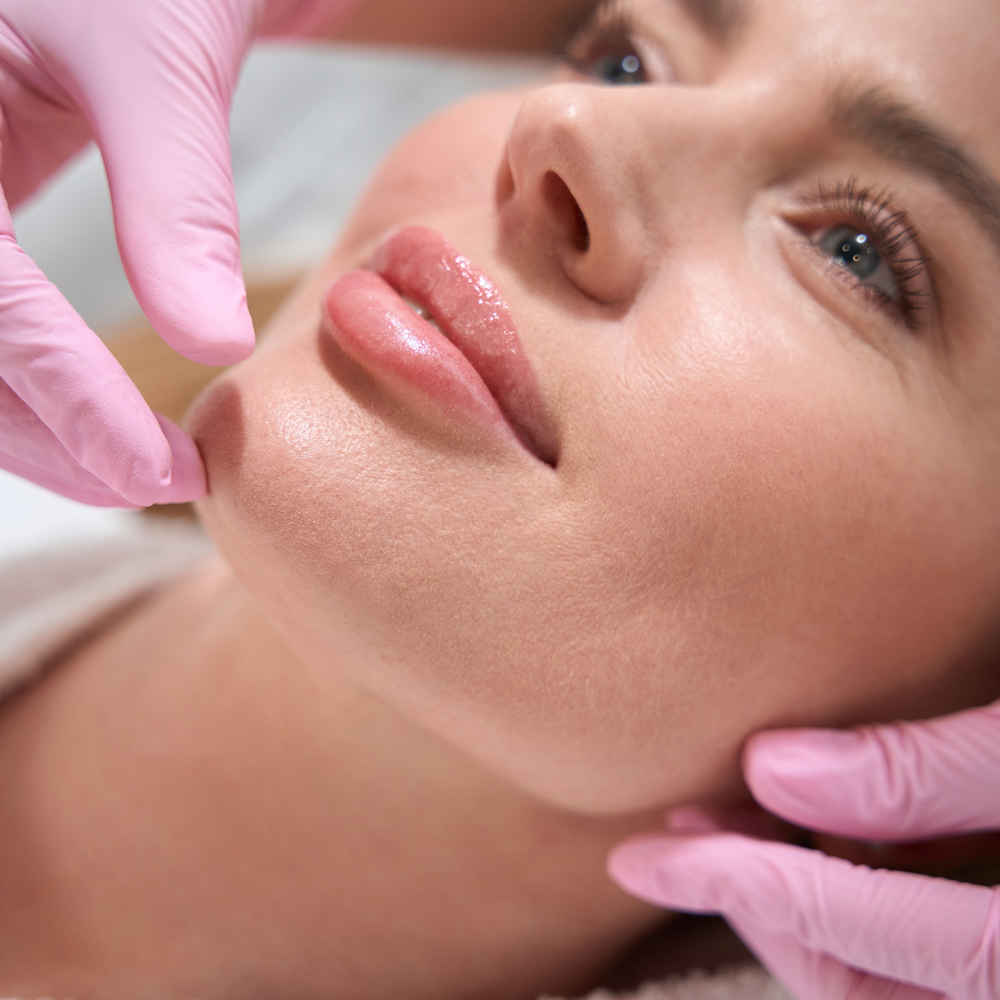 Facial plastic surgeon showing off patient's face after injecting dermal fillers