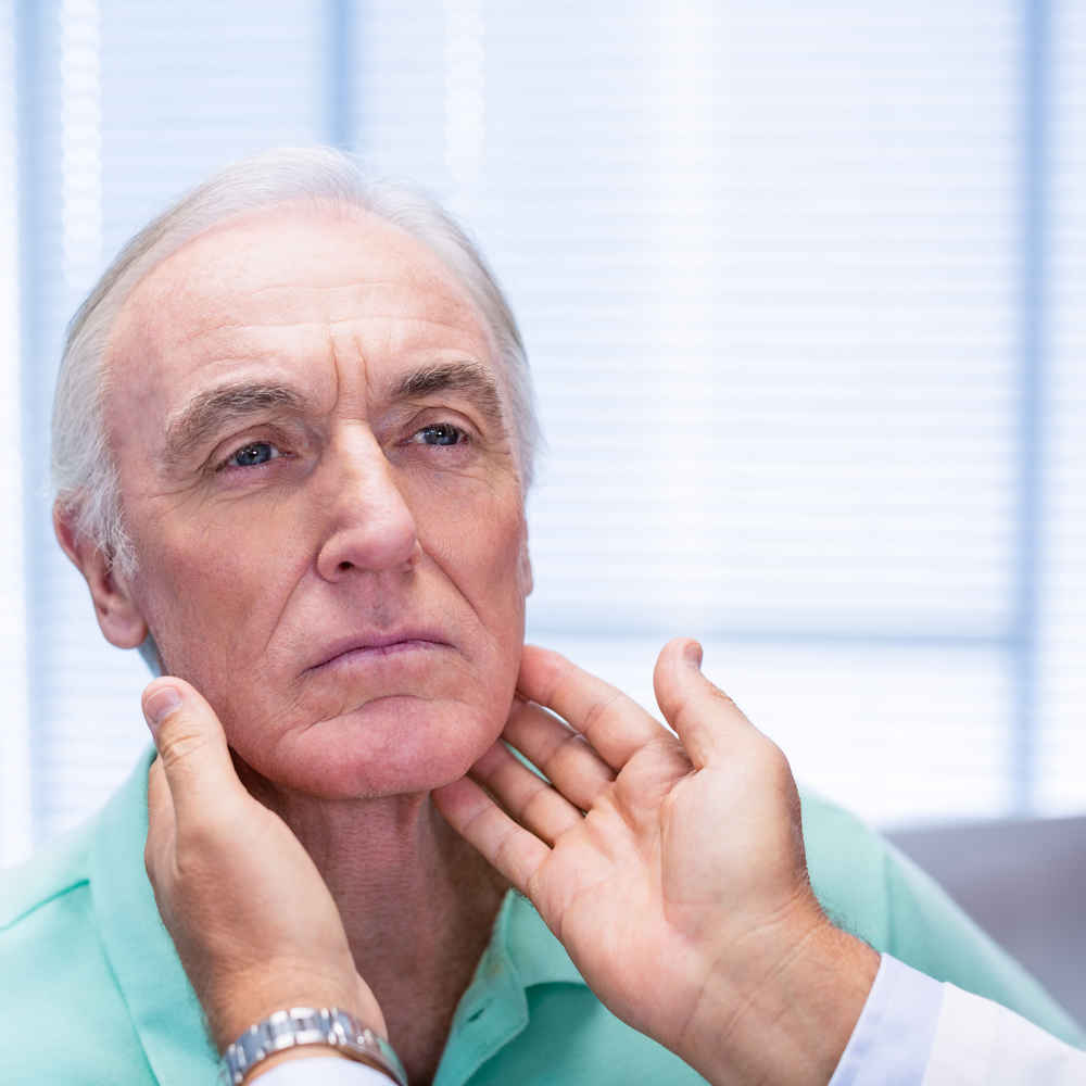 ENT doctor checking patient's neck