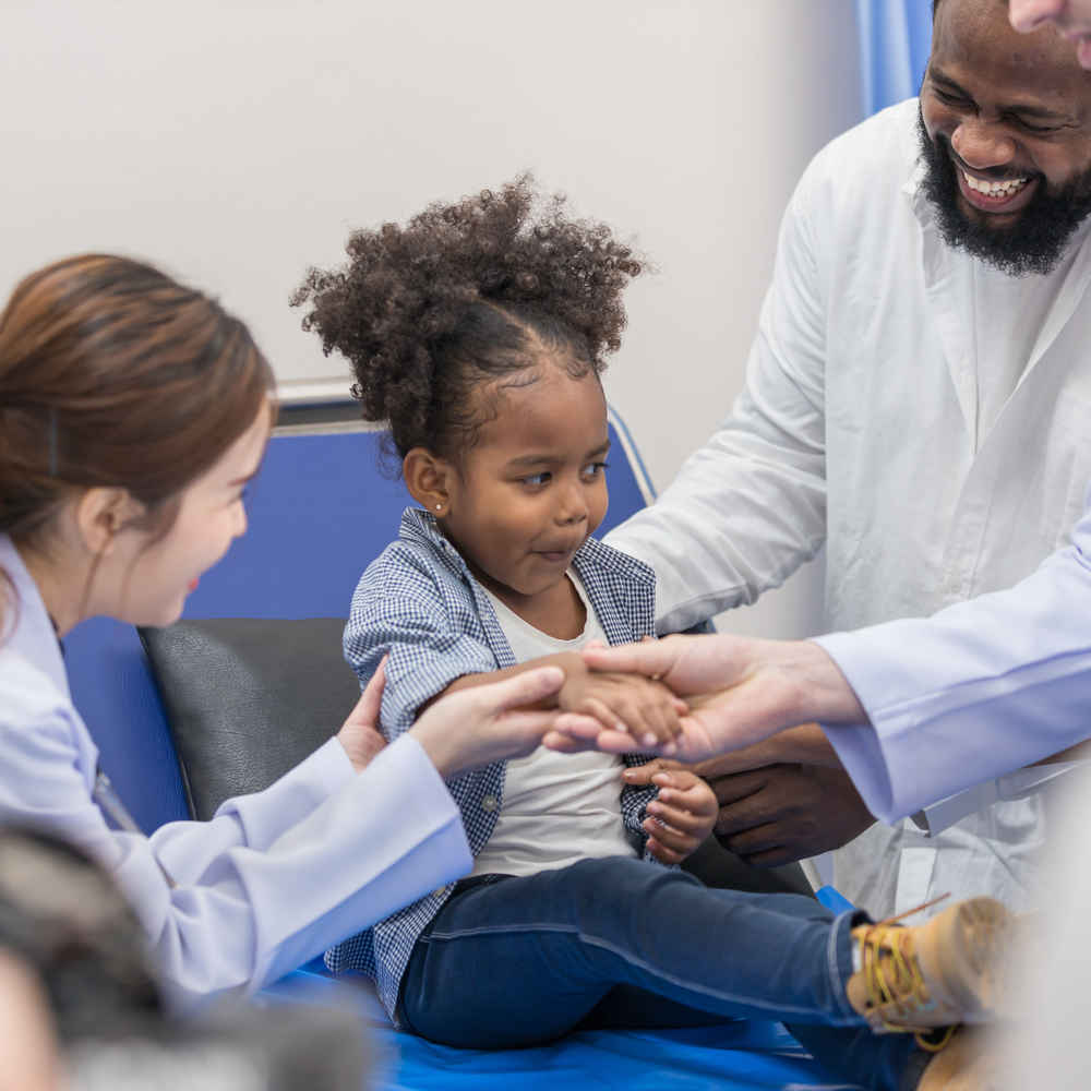 Group of ENT doctors checking on young child