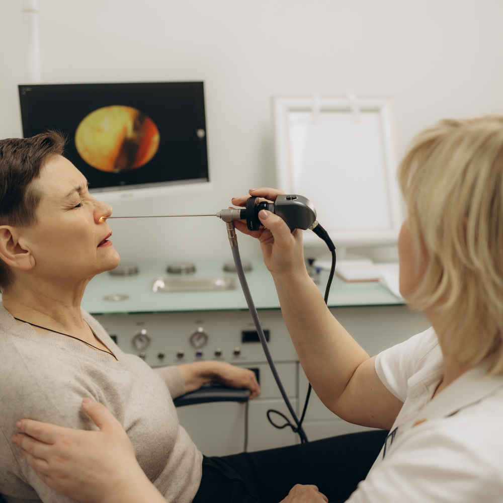 ENT doctor using sinus scope on patient